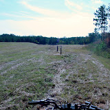 A well-vegetated landfill showing clear access to monitoring wells.