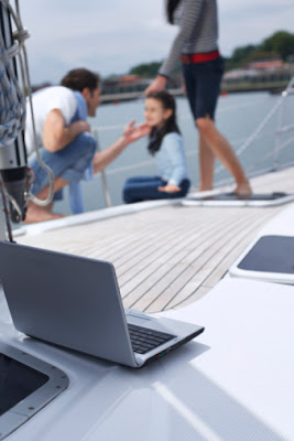 Apply for payday advance loans - online or over the phone! Laptop on a family sailboat used to apply for payday advance loans online.