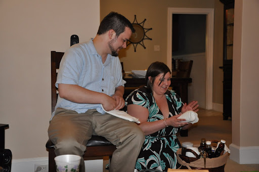 Corey and Jodi open a wedding present.