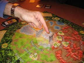 Castle Panic, things are not looking good! The finger shows our last remaing tower (there were once 6) and its impending destruction by the monsters