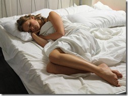 26 Jul 2007 --- Young Woman Asleep on Bed --- Image by © Bob Thomas/Corbis