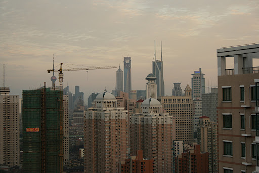 Daytime view facing east (towards Pudong) from my balcony. The Orient Pearl TV Tower is under the left side of the crane. The right edge of the crane points to the Jinmao Tower (tallest building in Shanghai) and the the right of that is the World Financial Center (soon to be the tallest building in Shanghai).