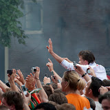 Everybody tries to get a snapshot of the dutch soccer players emerging from under the bridge
