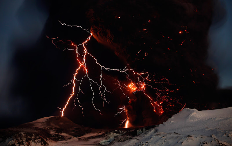 Lightning streaks across the sky as lava flows from a volcano in Eyjafjallajokul April 17, 2010. (REUTERS/Lucas Jackson)