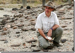 Dr. Rick Potts holds one of 500 handaxes made by Homo erectusthat he and his team uncovered at his research site at Olorgesailie, Kenya. Photo credit: © Jason F. Nichols