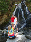 Darion taking a photo of Cindy and Chris at the waterfall