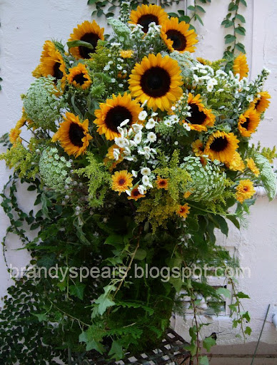 sunflowers summer wedding Photo A moss and ivy covered container filled 