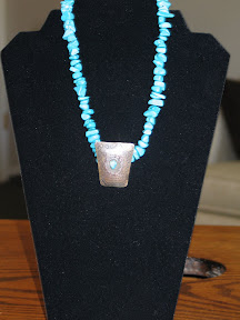 Turquoise and silver beads with western silver pendant.