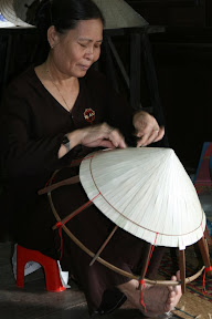 The famous conical hats are incredibly cheap everwhere, but require time and intricate effort to weave between each rice stalk.