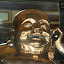 I can't talk! I'm in a glass box! Covered in gold! IN A BOX!