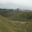 We think all these marks in the hill are young shrubs that have been planted in an attempt to create a forest.