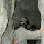 Clambering down into one of the many impossibly small tunnels that these guys work in each day.