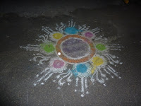During Diwali, female members of the family draw a 'Kolam' outside their home using rice powder.