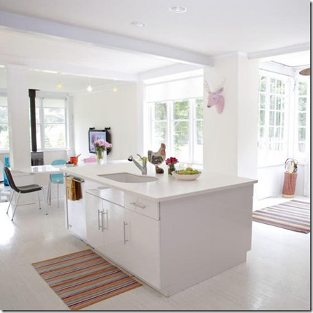 White bright airy open plan kitchen range cooker island unit dining area assorted colourful items art furniture sash windows real home L etc 09/2007 not used