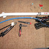 I liked the Infinity grip in the RV-8, so I am going to do the same in the RV-7.  I fit it to the stick after cutting off 3.75", so overall length of the stick is unchanged.  The switch behind the blue and green buttons were swapped.  5/16" socket put in the vertical lathe (drill press) and machined down to .41" diameter to get to the nut on each switch.  Later, I'll consolidate all ground wires inside the grip to minimize size of wire bundle exiting the grip.