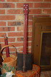 A Cigar Box Guitar Painted Cigar Box, Purpleheart Neck, Ebony Bridge and Nut Owned by Brad Tretola