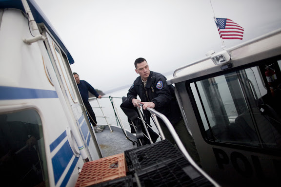 Suquamish Tribe Police Officer Michael Stewart boards the vessel "Casino" as its crew and divers harvest geoducks in Puget Sound near Suquamish, Washington on Tuesday, January 18, 2011. Part of Stewart's responsibility is to regulate the highly-lucrative geoduck harvest and deter poaching. Suquamish Tribe divers can earn between $1000-2000 a day harvesting these clams, which in large part are exported to Asian markets. "CREDIT: Mike Kane for The Wall Street Journal"