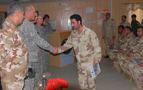 Brig. Gen. David Elicerio, deputy commander of operations for 34th Infantry Division congratulates one of 39 Iraqi Soldiers who graduated from the two-week Basic Military Intelligence Course at Contingency Operating Base Basra Jan. 14. (U.S. Army photo by Master Sgt. David Bennett)