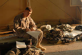 Master Sgt. Scott Wald, enlisted leader of the 34th Red Bull Infantry Division legal team, prepares his tote for customs inspection. The tote will be shipped home to join the Red Bulls when they return to Minnesota. (U.S. Army Photo by Pfc. J. Princeville Lawrence)