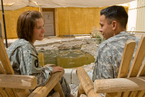 Spc. Stacy McCane (left), an awards specialist with the administrative section of 34th Red Bull Infantry Division, chats with her husband, Sgt. James McCane, an awards and officer evaluation report noncommissioned officer with command group, 34th Inf. Div., during a break at Contingency Operating Base Basra Sept. 5. The McCanes were recently married in St. Paul, Minn. while home on leave.  (U.S. Army photo by Sgt. Frank Vaughn)