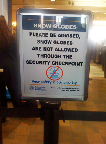 Please be advised, Snow Globes are not allowed through the security checkpoint Airport Sign: Please be advised, Snow Globes are not allowed through the security checkpoint