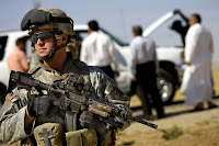 TALL AFAR, Iraq (July 13, 2006) - Army Spc. Brad Clark provides perimeter security for his fellow soldiers as they conduct a vehicle search.jpg