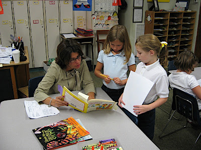 Mrs. Lewis and two 2nd grade students