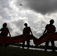Contract workers unload oil booms to protect marshlands along the Gulf of Mexico on May 13 in Hopedale, Louisiana.(AFP / Getty Images / John Moore) 