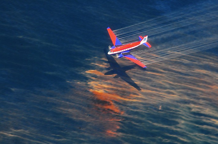 A Basler BT-67 fixed-wing aircraft releases dispersant over an oil discharge from the Deepwater Horizon oil spill, 5 May 2010. Reuters
