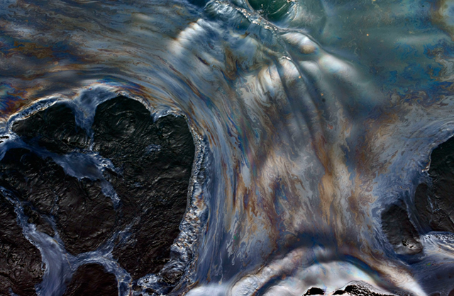Oily water is seen off the side of the Joe Griffin supply vessel at the site of the Deepwater Horizon oil spill containment efforts in the Gulf of Mexico on Saturday, May 8, 2010. (AP Photo / Gerald Herbert)
