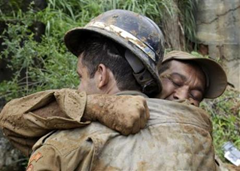 Firefighters react after recovering the body of Marcos Vinicius Franca, 8, after a landslide at Morro dos Prazeres slum in Rio de Janeiro April 7, 2010. Reuters / Sergio Moraes