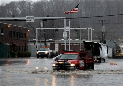 A vehicle makes its way through high water as a low-lying area in Elmsford, N.Y. floods Tuesday. Craig Ruttle / AP