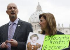 Peter Isely, left, speaks to journalists as Barbara Blaine displays a picture of herself as a child and a banner saying, 'Expose the Truth! Stop Secrecy,' as they take part in a demonstration against child sexual abuse by clergy, in St. Peter's Square at the Vatican March 25. (CNS photo / Alessandro Bianchi, Reuters) 