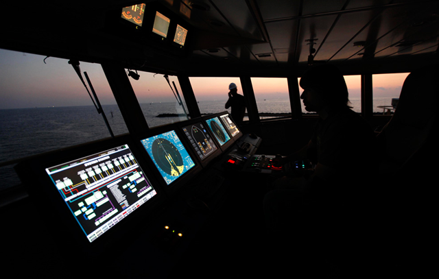 Capt. Demi Shaffer pilots the Joe Griffin as it enters the Gulf of Mexico carrying the containment vessel to the rig collapse site which will be used to try to contain the Deepwater Horizon oil, Wednesday, May 5, 2010. (AP Photo / Gerald Herbert)