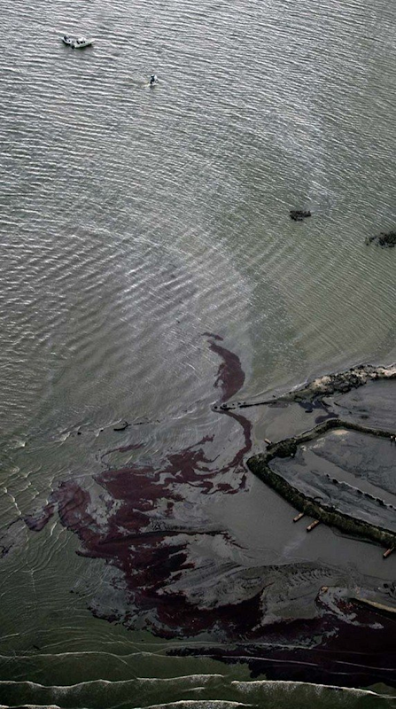 Heavy crude collects on the beach as small boats sit off the inland point of Coup Abel Pass of the Grand Terre Islands as oil inundates Barataria Bay, even as oil continues to spew from the Deepwater Horizon spill into the Gulf of Mexico, Wednesday, June 2, 2010. PHOTO BY TED JACKSON / THE TIMES-PICAYUNE