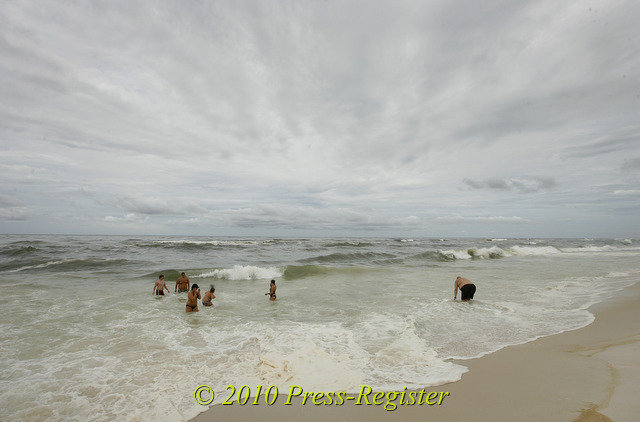 Vacationers from Arkansas play in the Gulf near the Romar Beach public access Thursday, July 1, 2010, in Orange Beach, Ala. A state official said oil has been confirmed to be in the seafloor off Alabama. Press-Register / Mike Kittrell