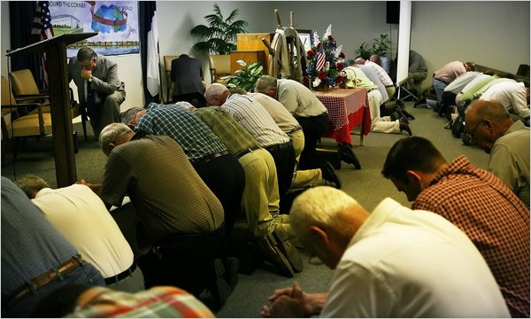 The assistant pastor at the Fishermen Baptist Church in Bon Secour, Alabama., asked the men of the congregation to come forward for a prayer, June 27, 2010. Nicole Bengiveno / The New York Times