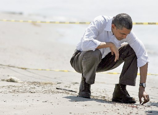 President Barack Obama was photographed 28 May 2010 getting a close look at a tar ball that had washed onto the beach at Port Fourchon. David Grunfeld, The Times-Picayune archive