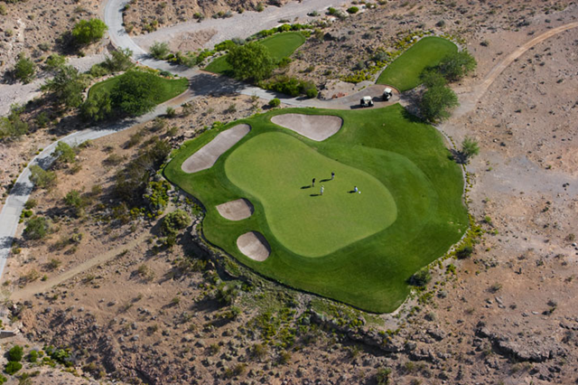 A foursome of golfers enjoy a well-watered green at a course on Las Vegas' west side, just yards away from the dry rock and sand of the surrounding desert. Vincent Laforet