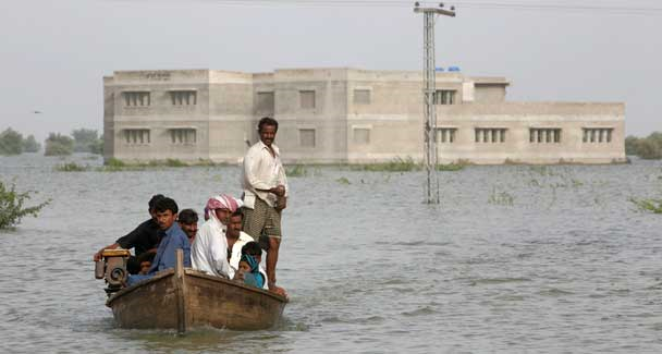 Villagers who are flood victims sit on a boat as they arrive from their village to seek higher ground in Dadu, some 320 kilometres north of Karachi, September 14, 2010. Reuters
