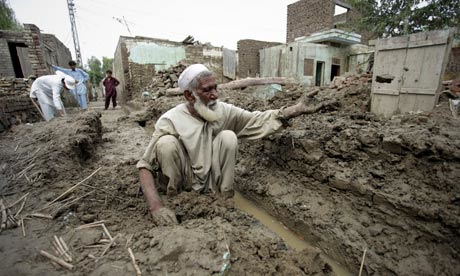 A survivor begins rebuilding his mud house in Nowshera, Pakistan. The monsoon deluge turned mud houses in north-west Pakistan into a sodden mess. Mohammad Sajjad / AP / Guardian