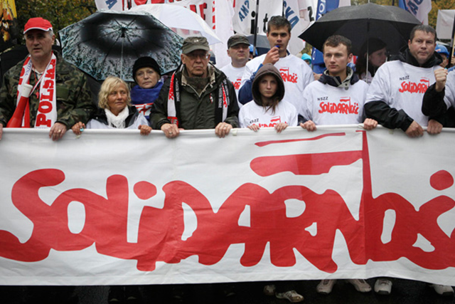 Protesters march behind Solidarity banner during demonstration against budget cuts, Warsaw, Poland, 29 September 2010. AP