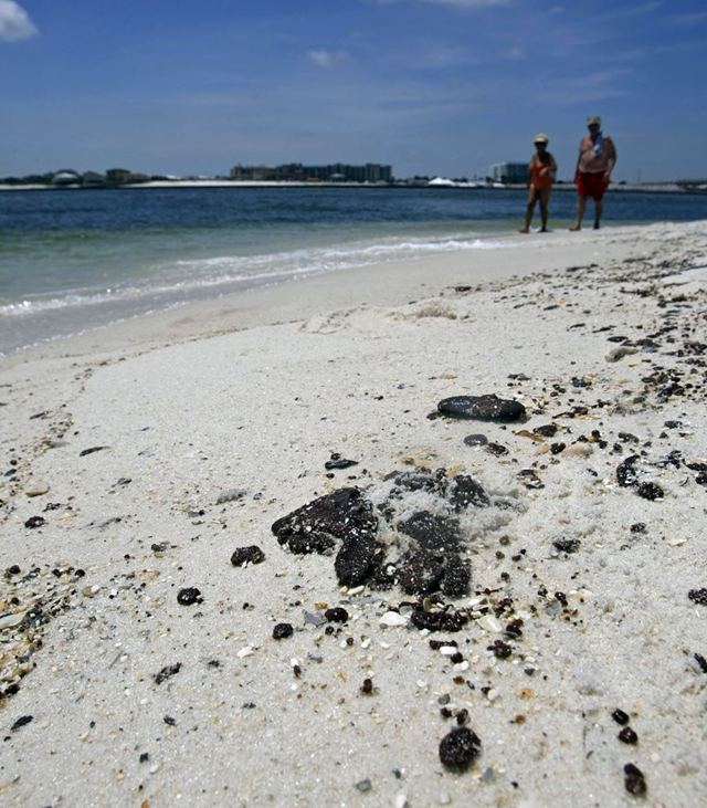 Oil dots the beaches as vacationers take to the waters at Perdido Point in this file photograph made on June 10, 2010. As BP PLC begins an intense effort Monday, Oct. 18, 2010, to remove lingering tar balls, tar mats and oil stains from Alabama’s beaches and restore the sugar-white sand, officials in the coastal towns plan to keep a daily watch on the cleanup. Press-Register photo