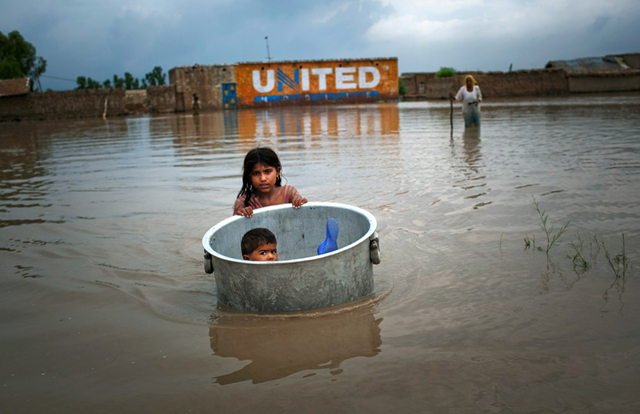A girl floats her brother across flood waters while salvaging valuables from their flood ravaged home on August 7, 2010 in the village of Bux Seelro near Sukkur, Pakistan. Daniel Berehulak / Getty Images