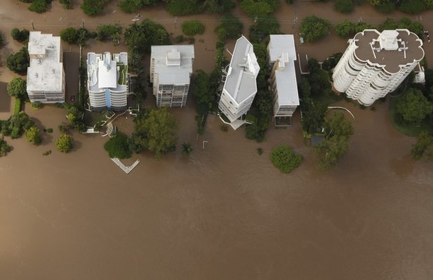 Apartment towers on the Brisbane River front are surrounded by floodwaters in Brisbane January 13, 2011. Flood water in Australia's third-biggest city peaked below feared catastrophic levels on Thursday but Brisbane and other devastated regions faced years of rebuilding and even the threat of fresh floods in the weeks ahead. REUTERS / Tim Wimborne