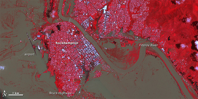 The inundated Australian city of Rockhampton, 7  January 2011. The image reveals the extent of the flooding in the city itself. Brown water covers rectangular blocks, particularly in southern Rockhampton. Tiny white flecks within the flooded area are buildings. Approximately 300 homes are believed to be flooded, reported the Australia Broadcasting Corporation. NASA Earth Observatory image created by Jesse Allen