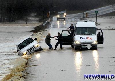 A car is washed off of a flooded road in Australia, 15 Jan 2011. More than 3000 people had fled their homes as Victoria is hit by floods. newsmild.com