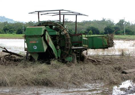 A piece of heavy farming machinery is stuck in a flooded field Friday near Grantham, Australia, 14 January 2011. John Pye / AP