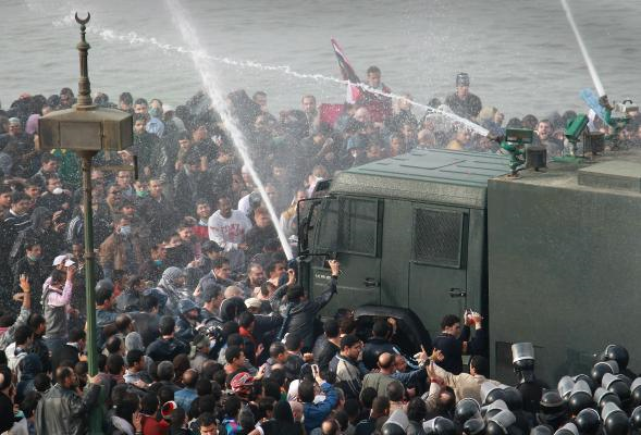 Riot police fire water cannons at protesters attempting to cross the Kasr Al Nile Bridge Jan. 28, 2011, in downtown Cairo. Thousands of police were on the streets of the capital and hundreds of arrests have been made in an attempt to quell anti-government demonstrations. Peter Macdiarmid / Getty Images