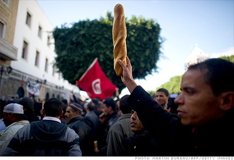 A Tunisian protester holds bread during a demonstration, January 2011. Martin Bureau / AFP / Getty Images